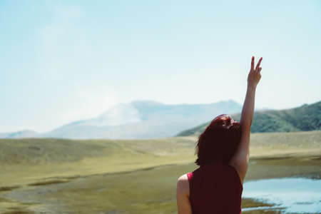 Man rise hands up to sky freedom concept with blue sky and summer field background.の写真素材