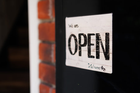 A business sign that says â€˜Openâ€™ on cafe or restaurant hang on door at entrance....