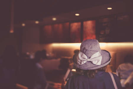 Selective focus woman waiting in line to order coffee at cafe shop background.の写真素材