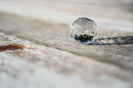 Crytal ball on old wood grunge texture background. Meditation and relax concept.の写真素材