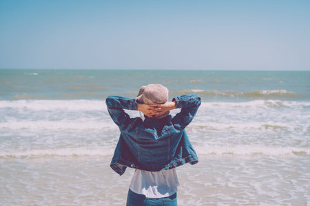 Woman rise hands up to sky freedom concept with blue sky and summer field background.の写真素材