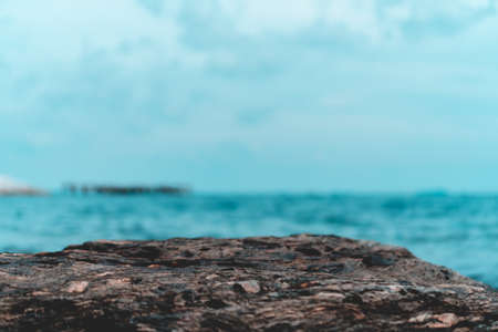 Selective focus od black stone texture for put product to show with beach in background.の写真素材