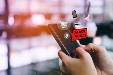 Women hand using smartphone do online selling for people shopping online in black friday with chat box, cart, dollar icons pop up. Social media maketing concept.の写真素材