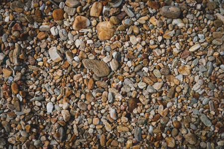 Many small stone brown color tone background texture.の写真素材