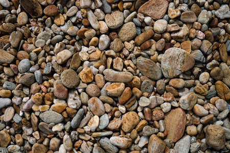 Many small stone brown color tone background texture.の写真素材