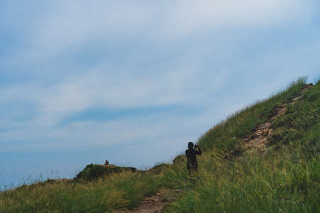 Man is trekking in mountain to take a photo scenery around nature background.の写真素材