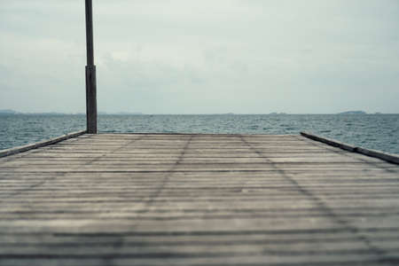 Wood small bridge walk way for sightseeing beside beach with green nature around background.の写真素材