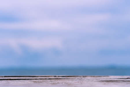 Selective focus of old wood table with blur beautiful beach background for display your product.の写真素材