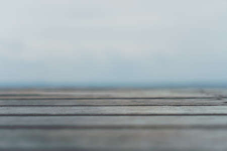Selective focus of old wood table with blur beautiful beach background for display your product.の写真素材