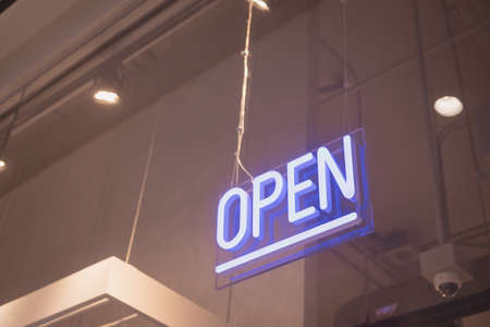 A business sign that says âOpenâ on cafe or restaurant hang on door at entrance. Vintage color tone style.の写真素材