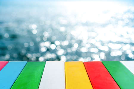 Selective focus of old wood table with blur beautiful beach background for display your product.の写真素材