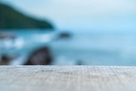 Selective focus of old wood table with blur beautiful beach background for display your product.の写真素材