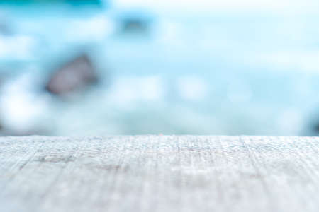 Selective focus of old wood table with blur beautiful beach background for display your product.の写真素材