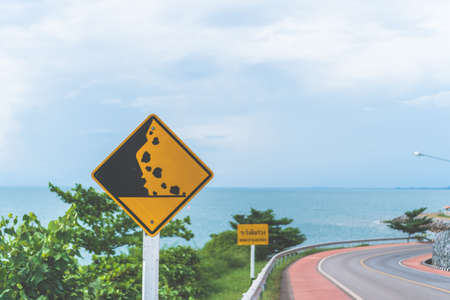 Traffic sign show beside road with beach view background.の写真素材