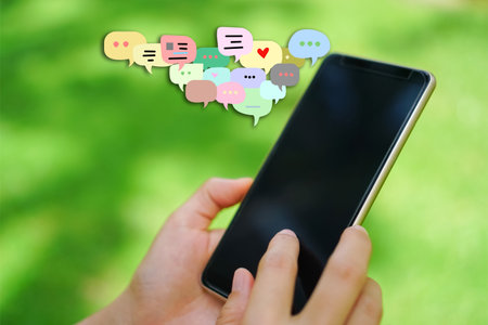 Woman hand using smartphone with chat icon background. Business communication social network...