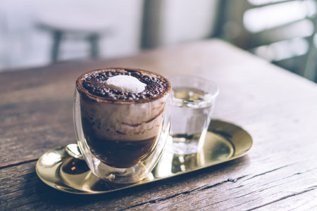 Black coffee or Americano on table with film vintage tone background.