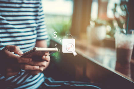 Women hand using smartphone do online selling for people shopping online with chat box, cart, dollar icons pop up. Social media maketing concept.の写真素材