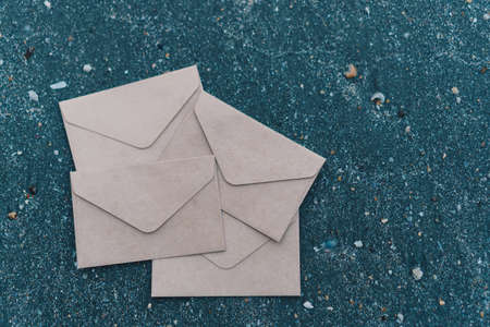 many od envelope imply for sending mail on sand texture background at beautiful beach.の写真素材