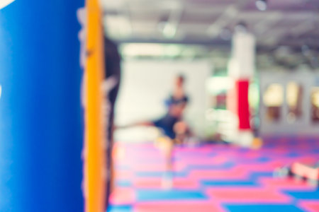 Blur man in fitness gym are boxing with boxing sack abstract background.