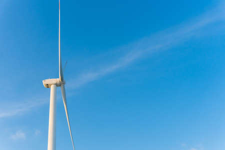 Wind energy converter as wind turbine ecology system clean power with blue sky background.の写真素材