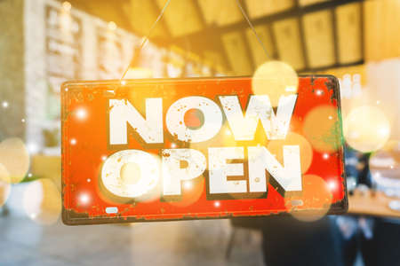 A business sign that says open on cafe or restaurant hang on door at entrance. Vintage color tone style.の写真素材