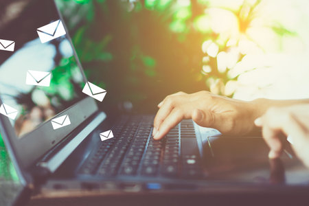 Woman hand using smartphone to send and recieve email for business on bokeh vintage color tone...