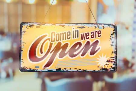 A business sign that says openâon cafe or restaurant hang on door at entrance. Vintage color tone style.の写真素材
