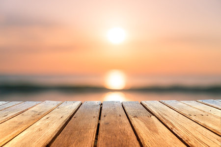 Selective focus of old wood table with blur beautiful beach background for display your product.の写真素材