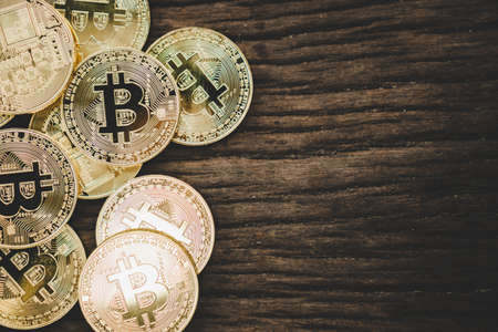 Stack of bitcoins symbol with old wood board background with copyspace that you can put text on.の写真素材