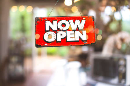 A business sign that says open on cafe or restaurant hang on door at entrance. Vintage color tone style.の写真素材