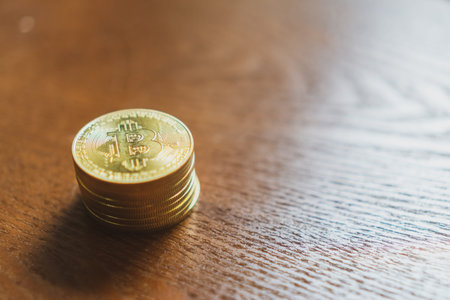 Stack of bitcoins symbol with old wood board background with copyspace that you can put text on.