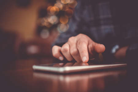 Woman hand using smartphone in cafe shop background. Business, financial, trade stock maket and social network concept.の写真素材