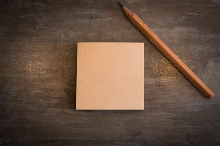 Top view closed up of  blank space yellow post note with pencil abstract background.の写真素材
