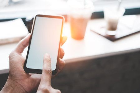 Woman hand use smartphone to do work business, social network, communication with white screen as copyspace in public area.の写真素材