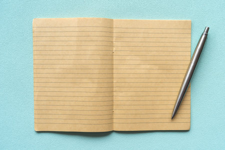 Top view closed up of blank space yellow notebook with line texture and pen abstract background.