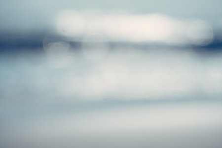 Blur tropical nature clean beach and white sand in summer with sun light blue sky and bokeh abstract...