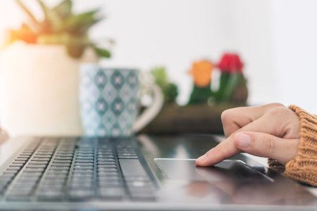 Woman hand using laptop or smartphone to work study on work desk with clean nature background...