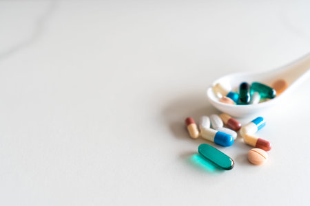 Mixed of pill or tablet medicine on white spoon on white background. Health care medicine cure...
