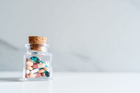 Top view of medicine tablets pour from pills bottle of marble texture white background. Health care medical lifestyle trend concept.の写真素材