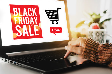 Women hand using computer shopping big sale in black friday online with cart, dollar icons on laptop...