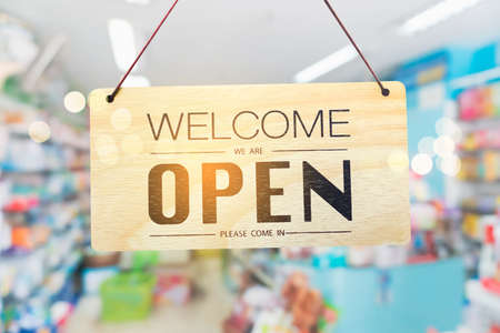 A business sign that says open on cafe or restaurant hang on door at entrance. Vintage color tone style.の写真素材