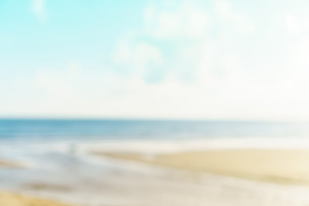 Blur summer bokeh beach with sun light and blue sky background.の写真素材