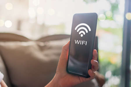 Wifi sign icon and connection screen of smartphone with top view city background. Financial business technology freedom dream life using internet freedom life concept.の写真素材