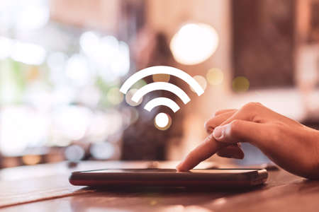 Wifi sign icon and connection screen of smartphone with top view city background. Financial business technology freedom dream life using internet freedom life concept.の写真素材
