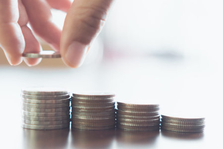 Business financial success concept. Gold coins on table and green nature bokeh background.Bullish...