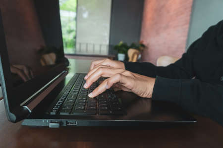 Woman hand using laptop to work study on work desk with clean nature background background. Business, financial, trade stock maket and social network concept.の写真素材