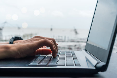 Woman hand using laptop to work study on work desk with clean nature background background....