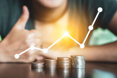 Business financial successful freedom concept  with icon growth graph uptrend and Gold coins money stack on table.の写真素材