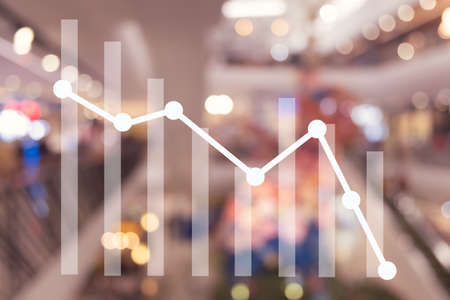 Down trend graph on blur mall department store background. Concept of business become not good.の写真素材