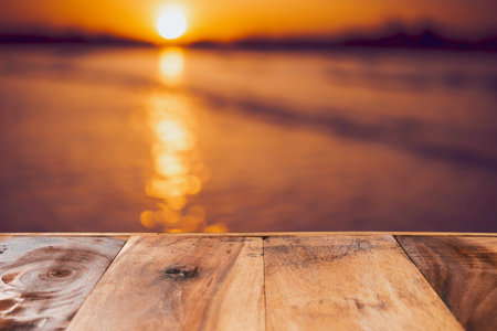 Selective focus of old wood table with blur beautiful beach background for display your product.の写真素材